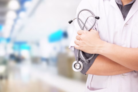 doctor-with-stethoscope-hands-hospital-background_1423-1.avif